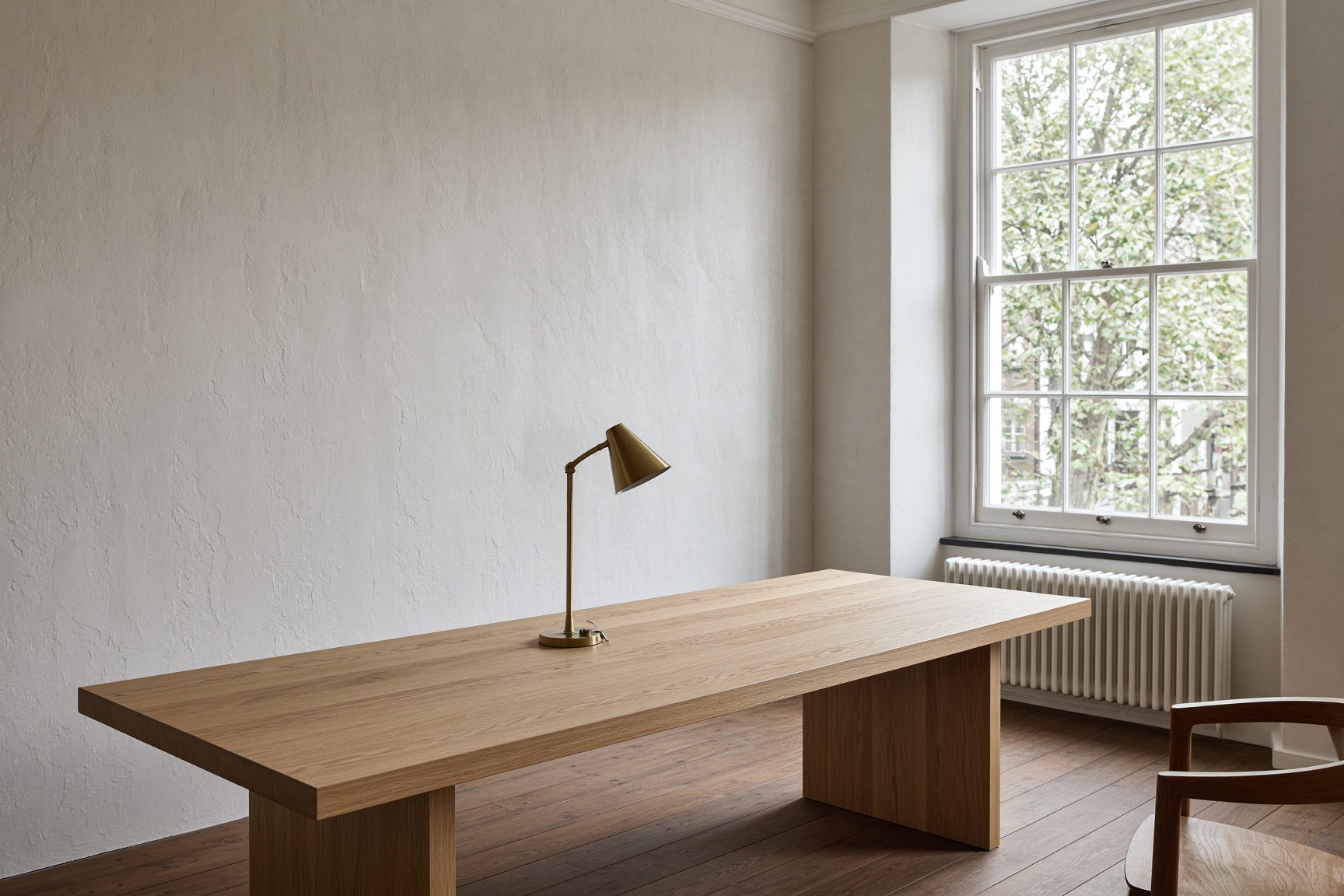 A quiet studio table beside a sash window